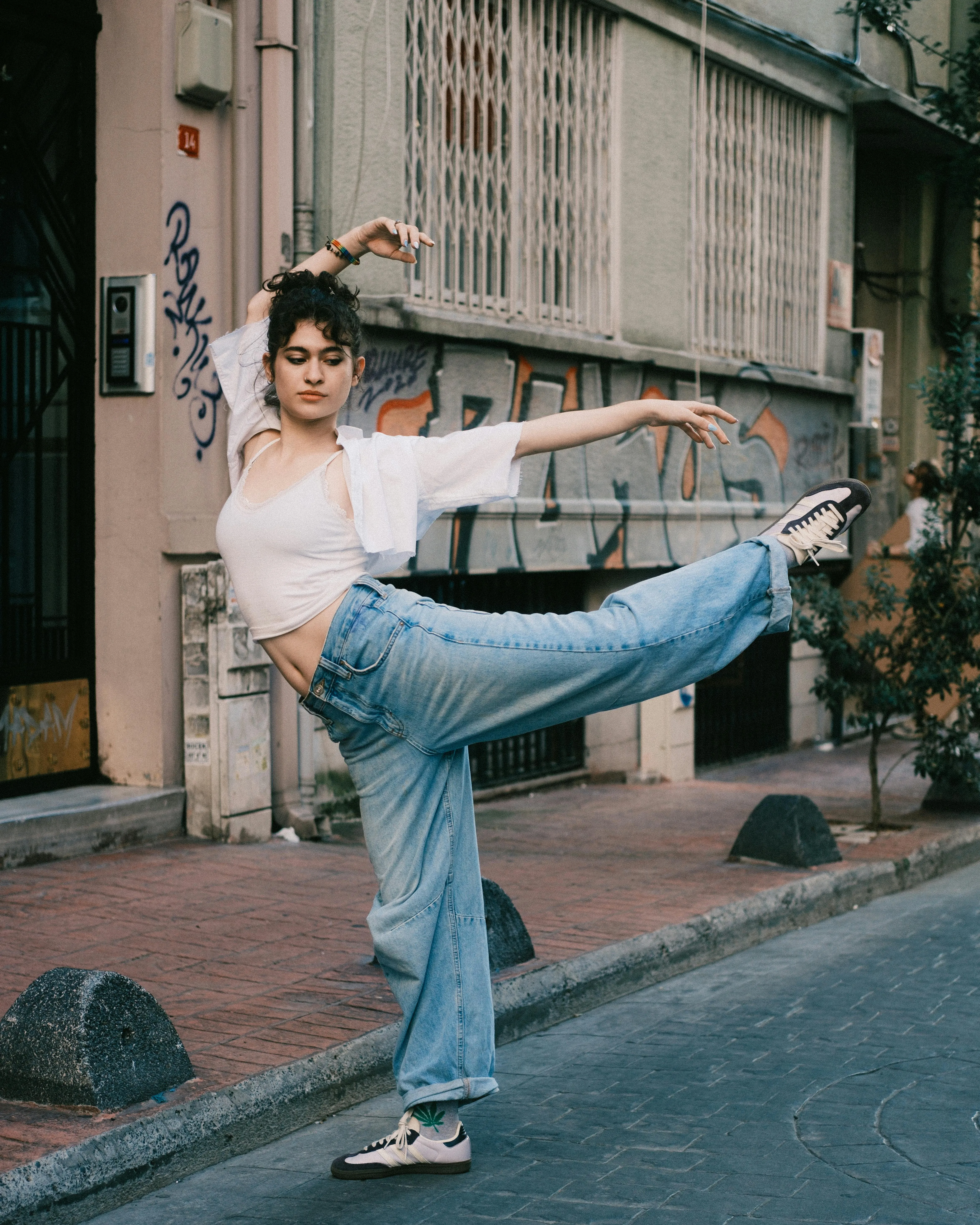 Ballarina de ballet urbà realitzant una postura de ball a l'aire lliure