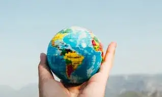 Una mà que agafa una bola del món