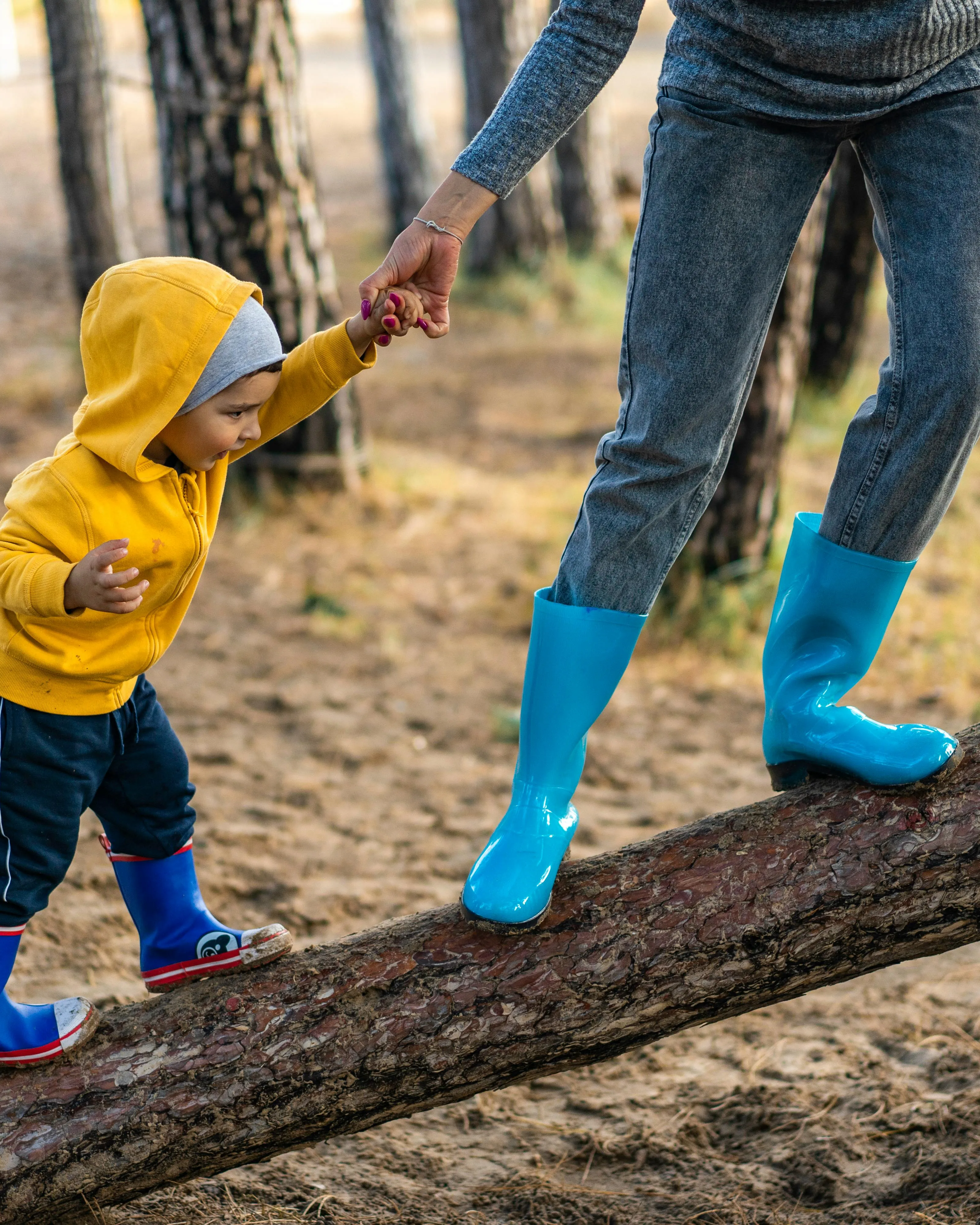 Adult ajundant a un infant a pujar a un arbre. Font: Pexels - Oleksandr P