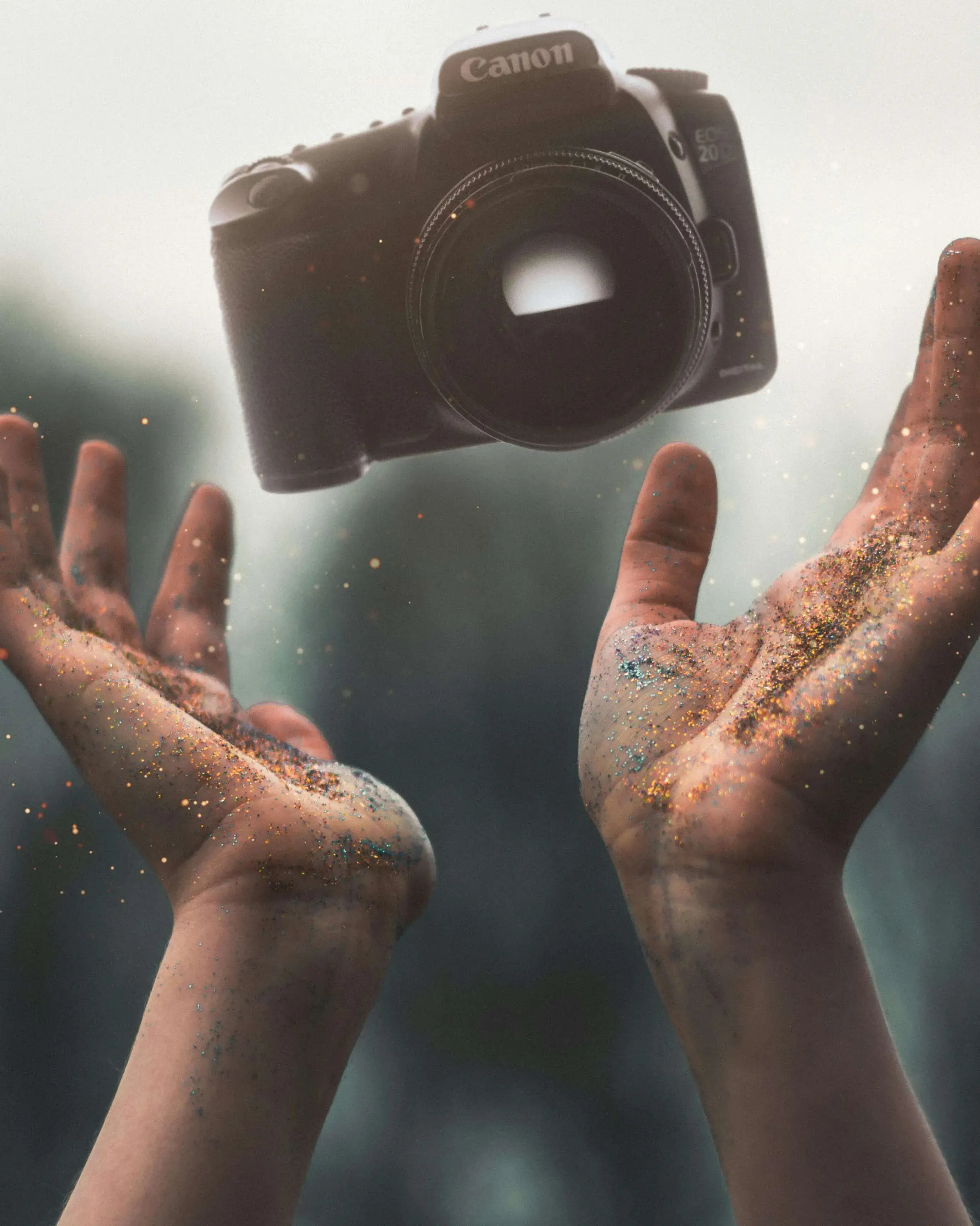 Mans plenes de sorra tirant enlaire una càmera de fotografiar Mans plenes de sorra tirant enlaire una càmera de fotografiar